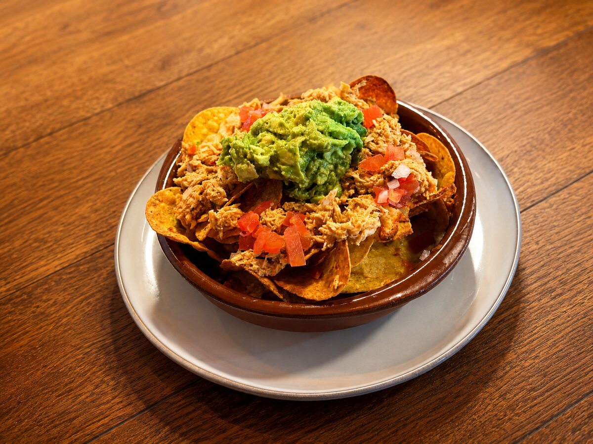 Loaded nachos with pulled chicken and guacamole
